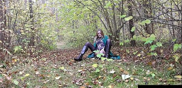  Cute exhibitionist peeing in the woods as she strokes her pussy